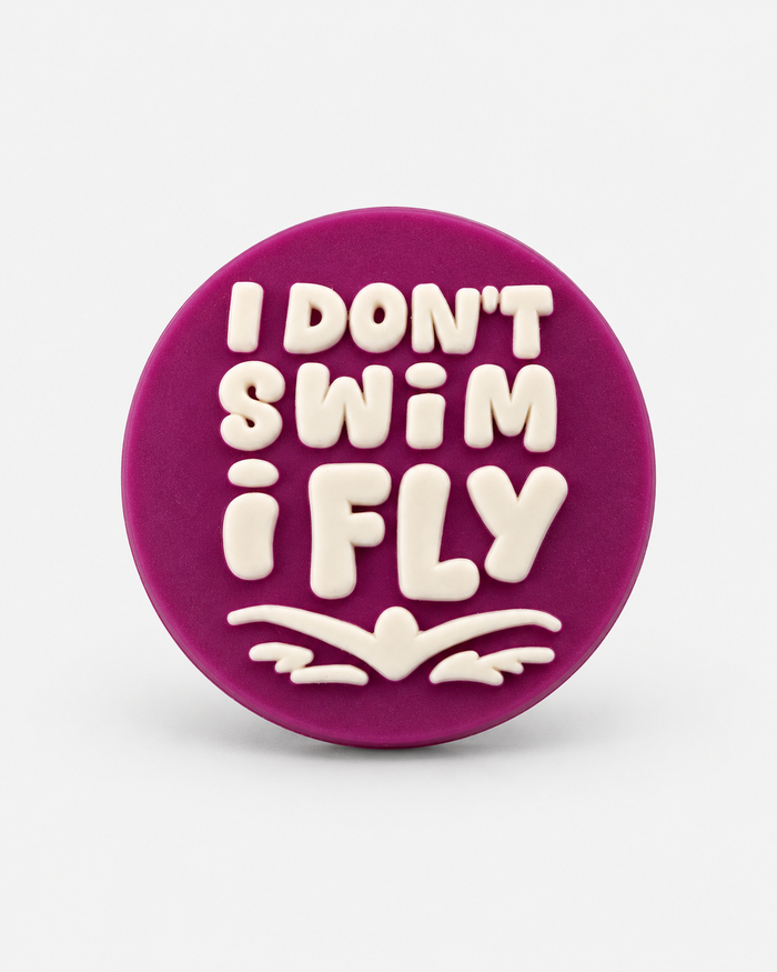 purple I DON'T SWIM I FLY croc charm — studio product photo
